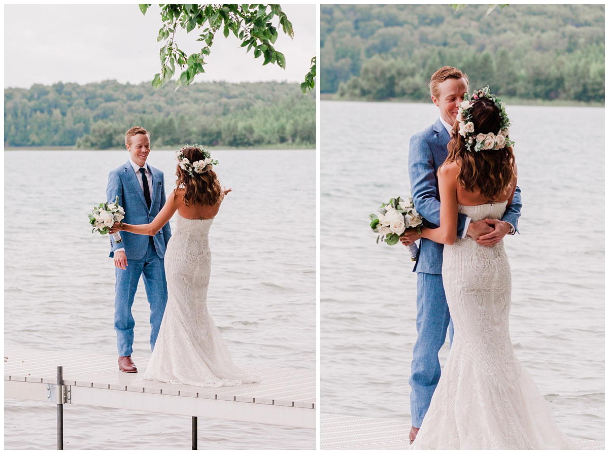 groom turns around to see his bride for the first time during a First Look ceremony on a dock over a lake