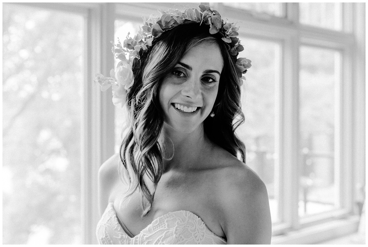 Brunette Bride is relaxed and happy wearing a flower crown looks at the camera and smiles