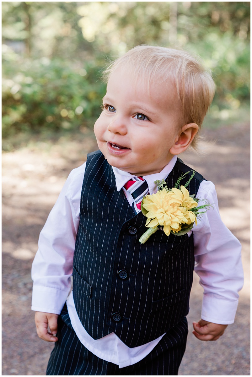 adorable little blonde toddler dressed up for a wedding captured perfectly by the right wedding photographer