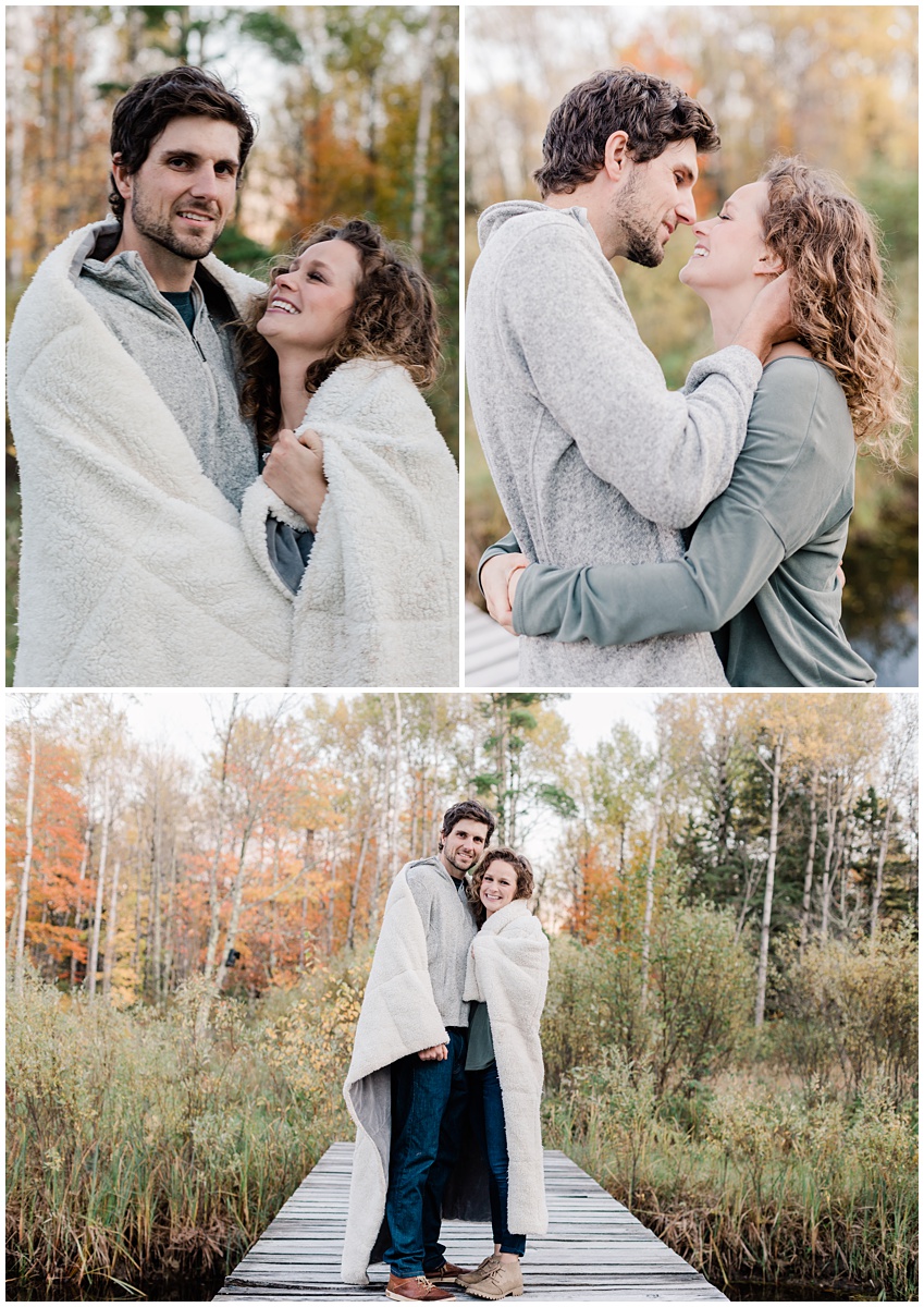 couple poses for engagement photos in a forest, wrapped in a blanket to announce their engagement. comfort and cashmere photography