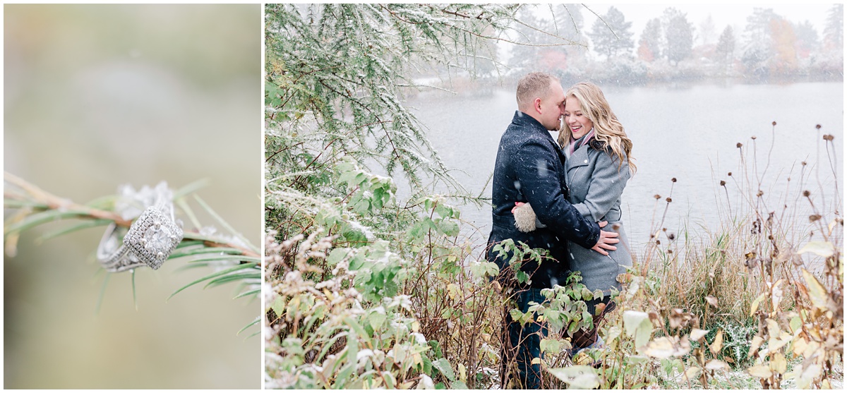 A beautiful engagement ring hangs from a snowy branch while the engaged couple enjoys a snuggle beside the lake at Brighton Beach in Duluth