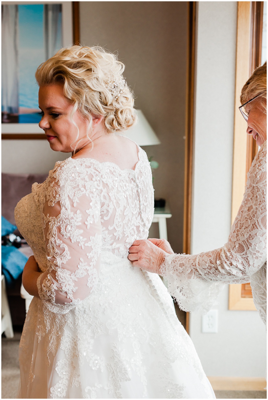 a mother does up the buttons on her daughter's wedding dress while the bride gets ready for the big day! IMage by comfort and cashmere photography