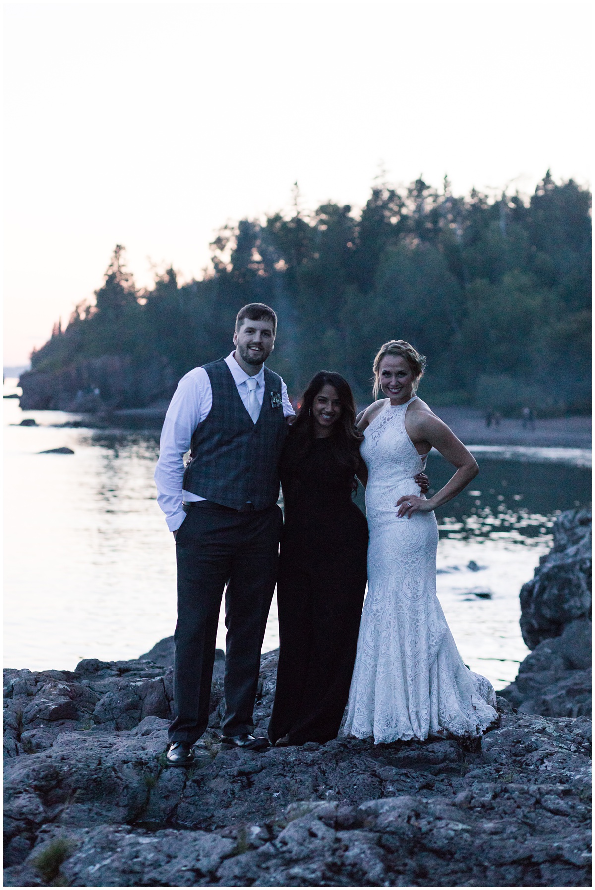 Rohana Olson of Comfort and Cashmere Photography poses for a fun photo with her bride and groom at the end of their wedding day