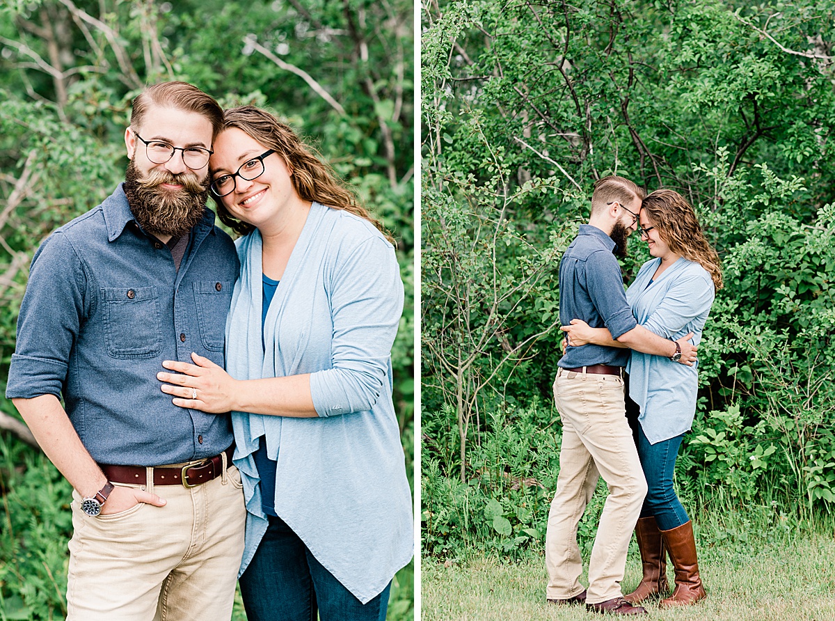 a couple celebrates their engagement and poses together in the greenery around Enger Tower Park in Duluth, Minnesota with Comfort and Cashmere Images