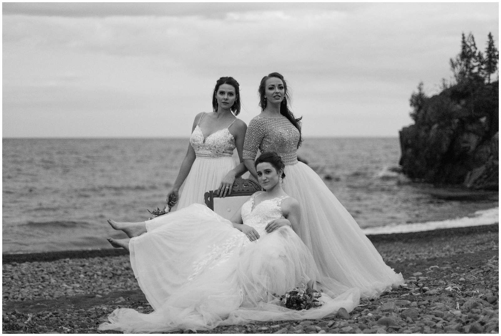three gorgeous brides wearing a variety of dress styles pose during a styled shoot at Minnesota's Black Beach