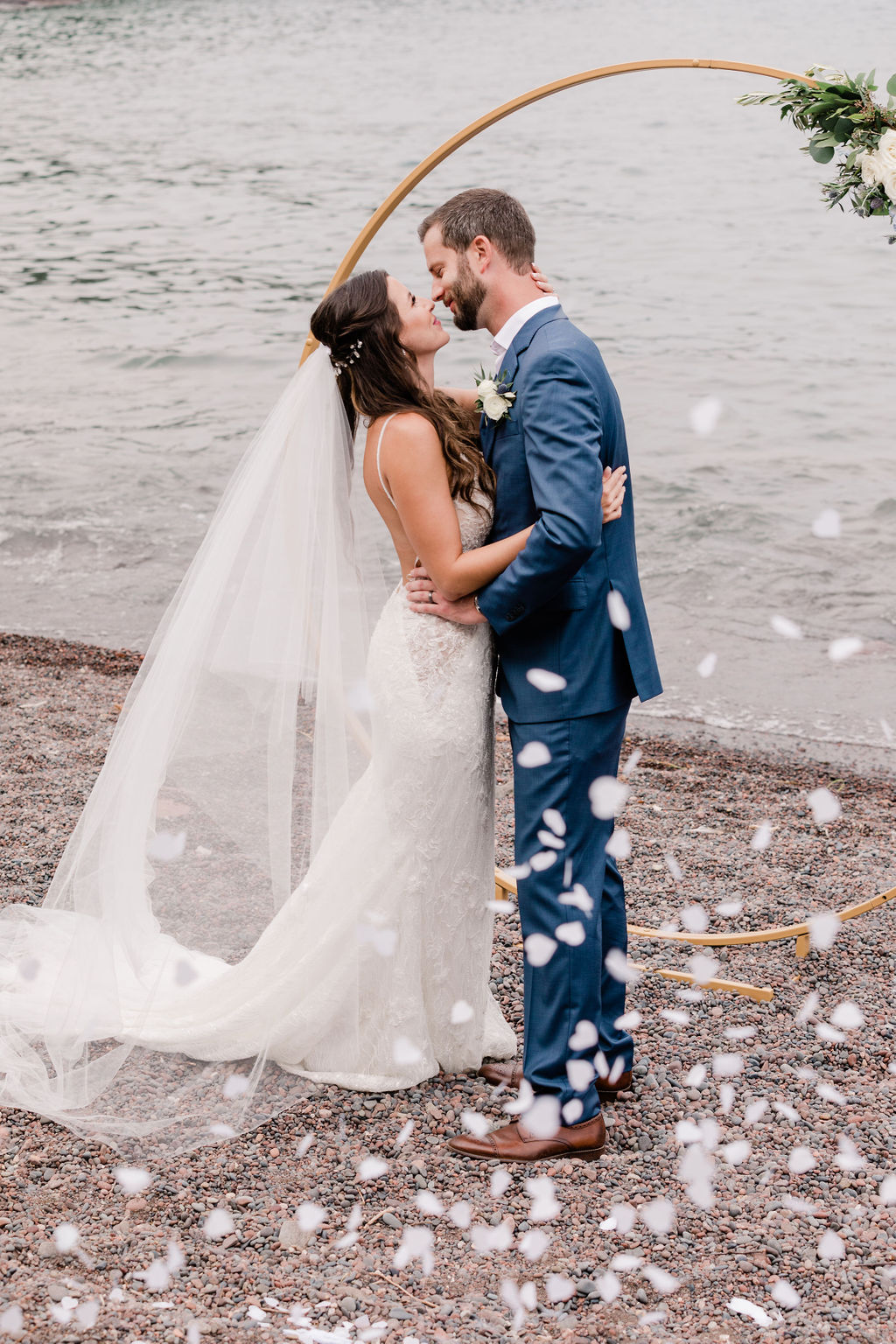 Bride and Groom share their first kiss during their elopement ceremony at Sugar Loaf Cove on the North Shore of Lake Superior with Comfort & Cashmere images.