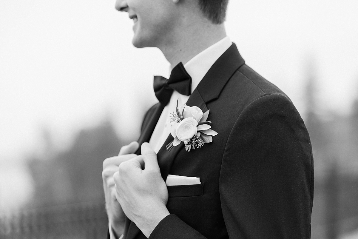 A groom adjusts his tux as he waits for his first look with his Minnesota bride. 