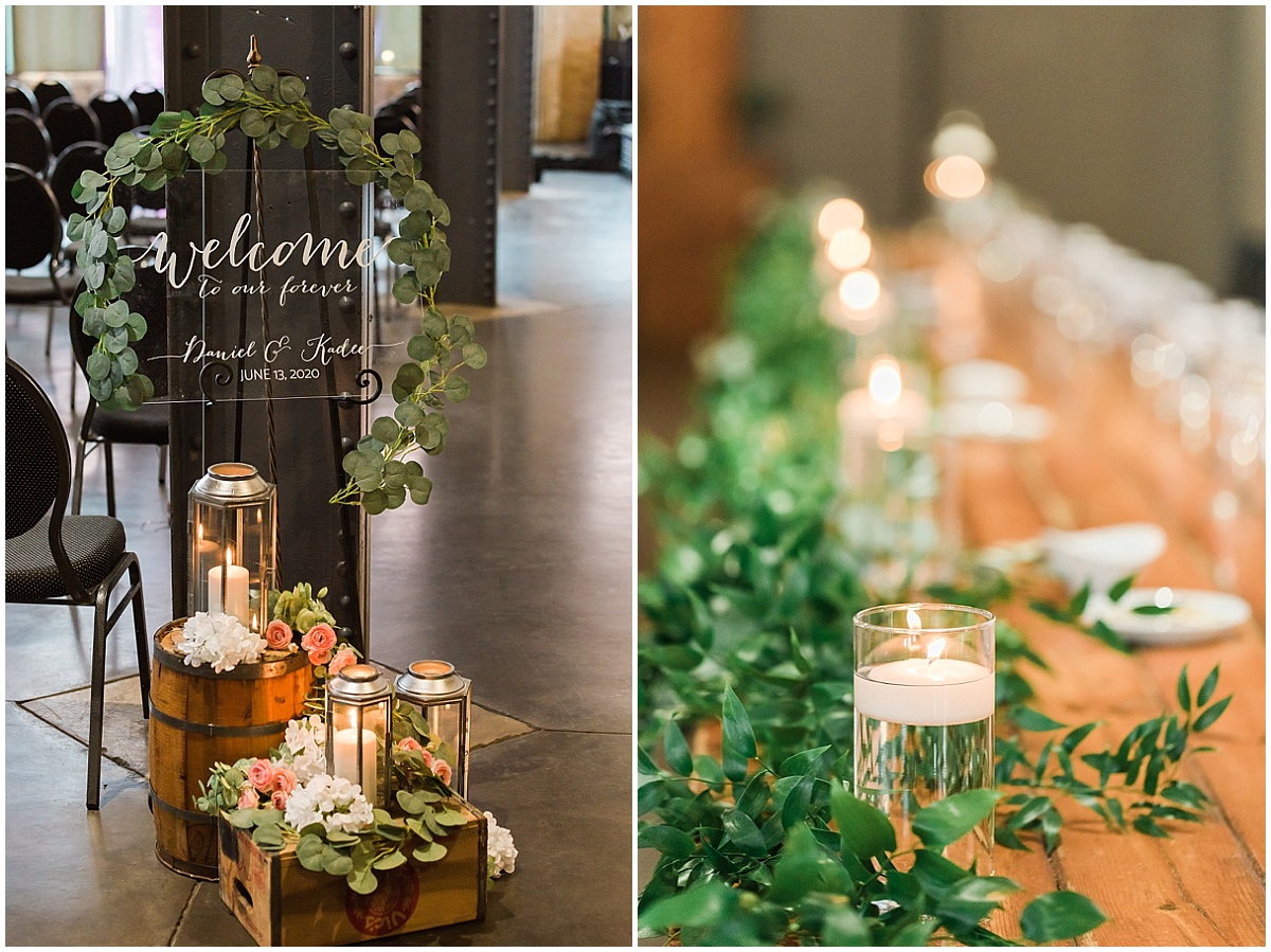 A welcome sign surrounded by wood barrels, flowers and candle lanterns at a Clyde Iron Works wedding in Duluth.