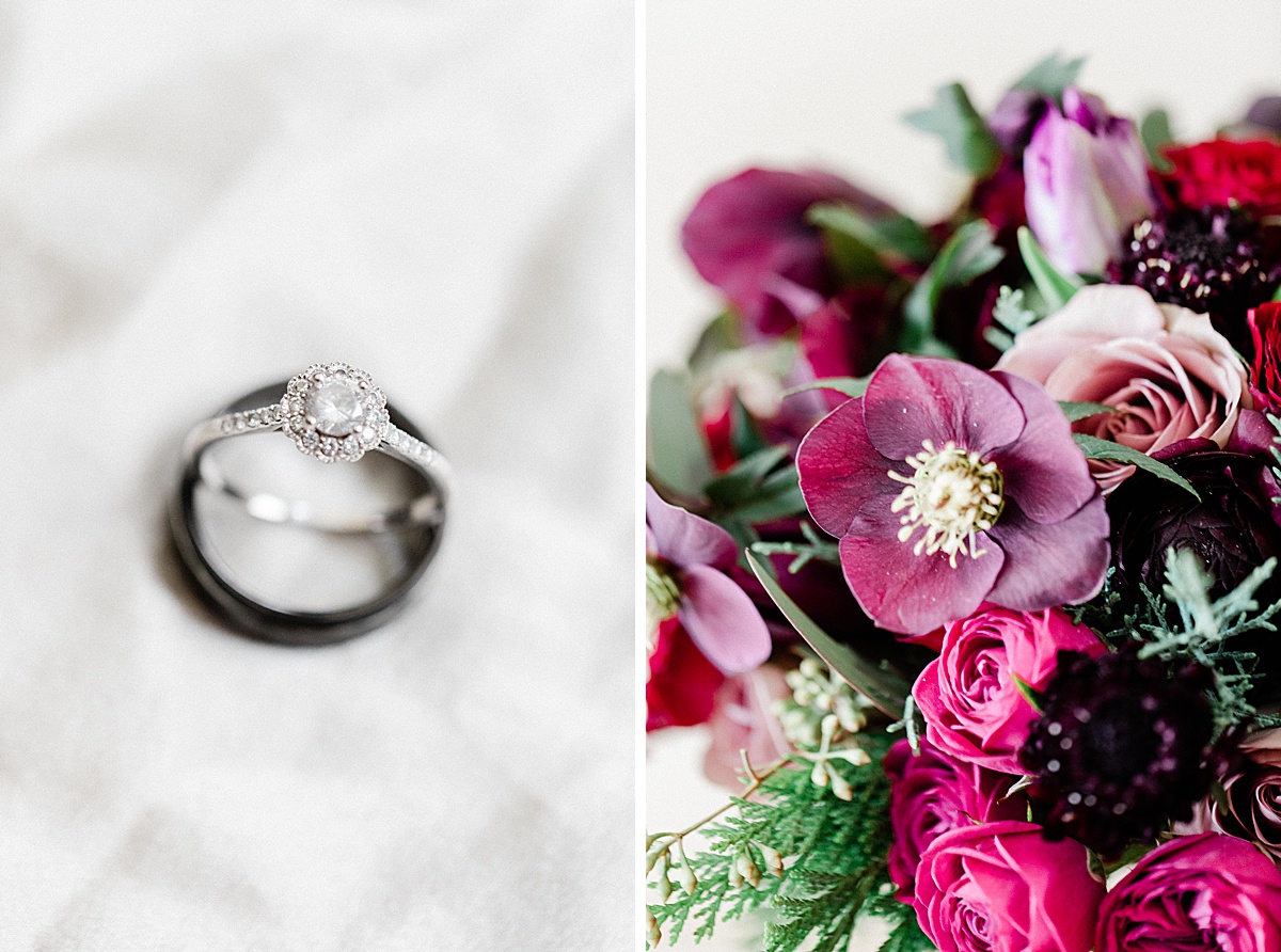 close up of a delicate solitaire engagement ring in the shape of a flower next to a purple, pink, and green bridal bouquet by Saffron & Grey