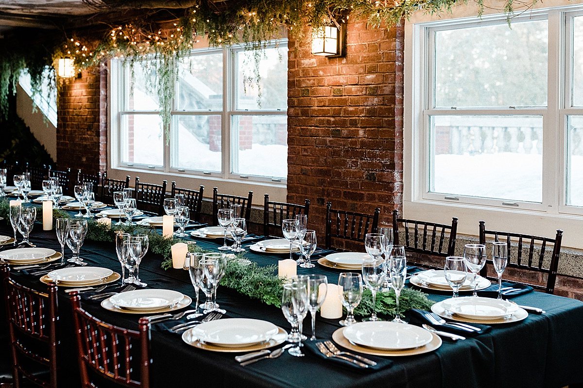 gorgeous christmas wedding table setting with candles and greenery at the Glensheen Mansion in Duluth