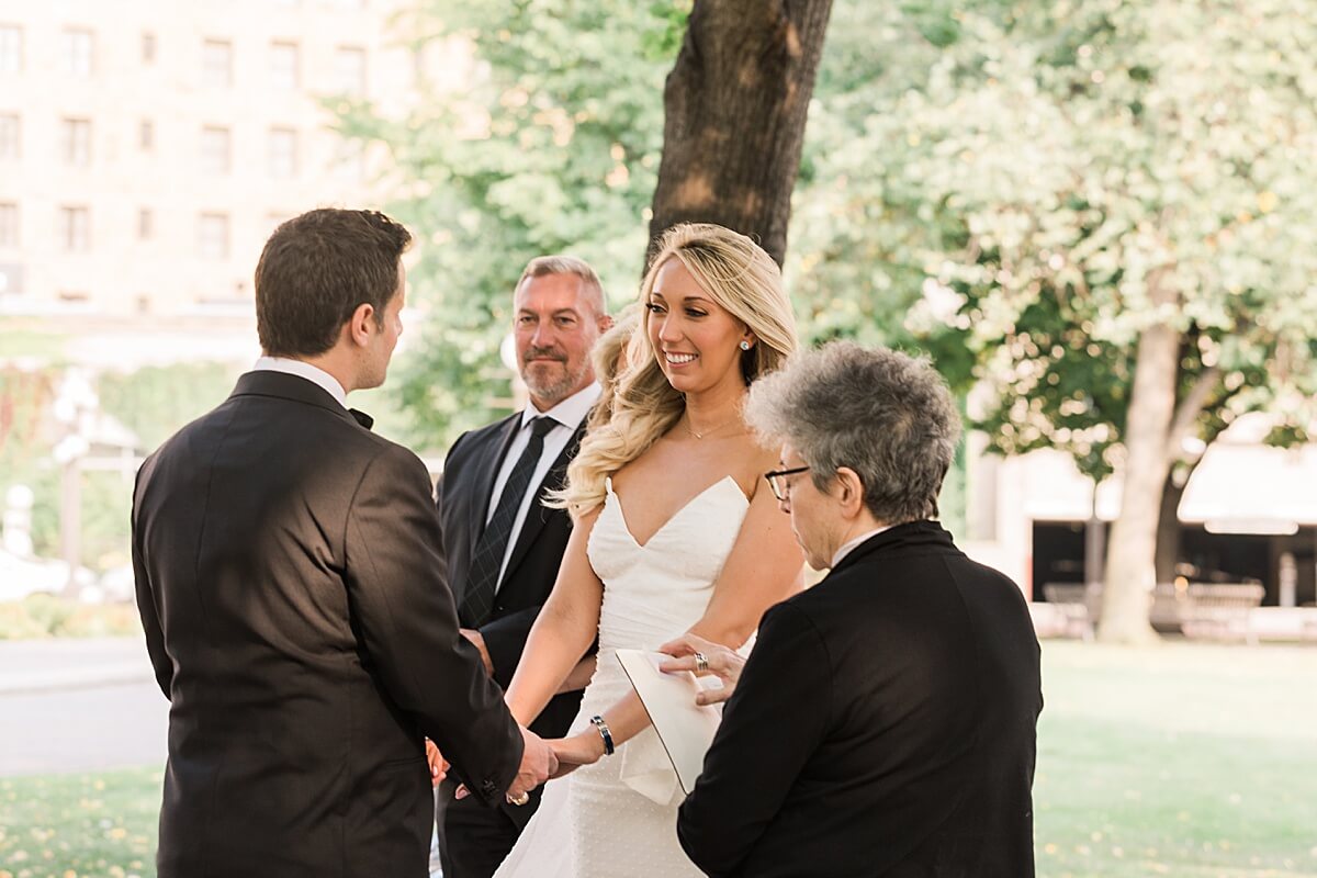 bride smiling at groom during vows in rice park downtown st paul