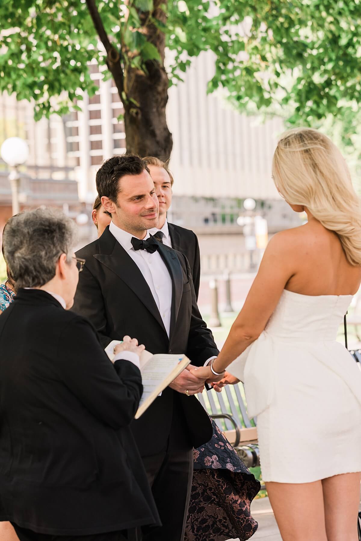 bride smiling at groom during vows in rice park downtown st paul