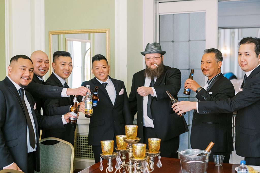 groom and groomsmen having a few beverages before the first look
