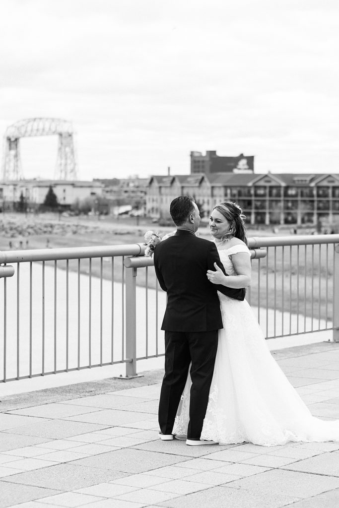 couple standing near Greysolon in Duluth overlooking park point