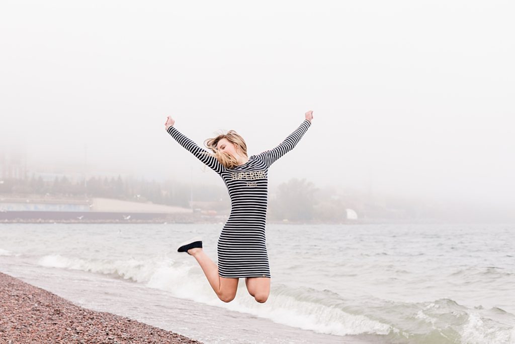senior portrait duluth near lake superior girl jumping in the air