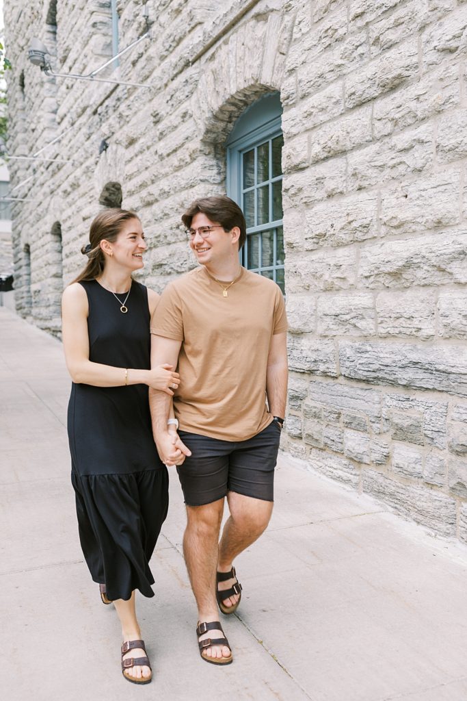 Minneapolis engagement session couple is walking holding hands