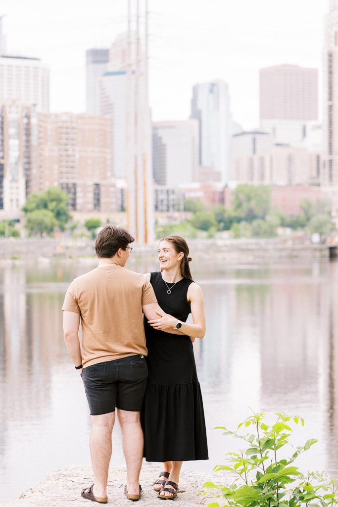 Couple on stone step near Stone Arch Bridge for their Minneapolis Engagement Session